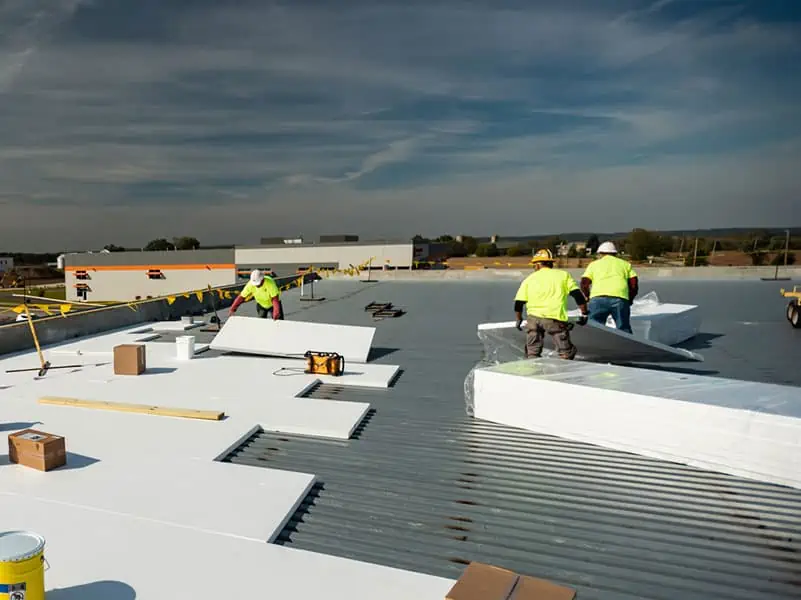 Commercial roofing crew working on a flat roof